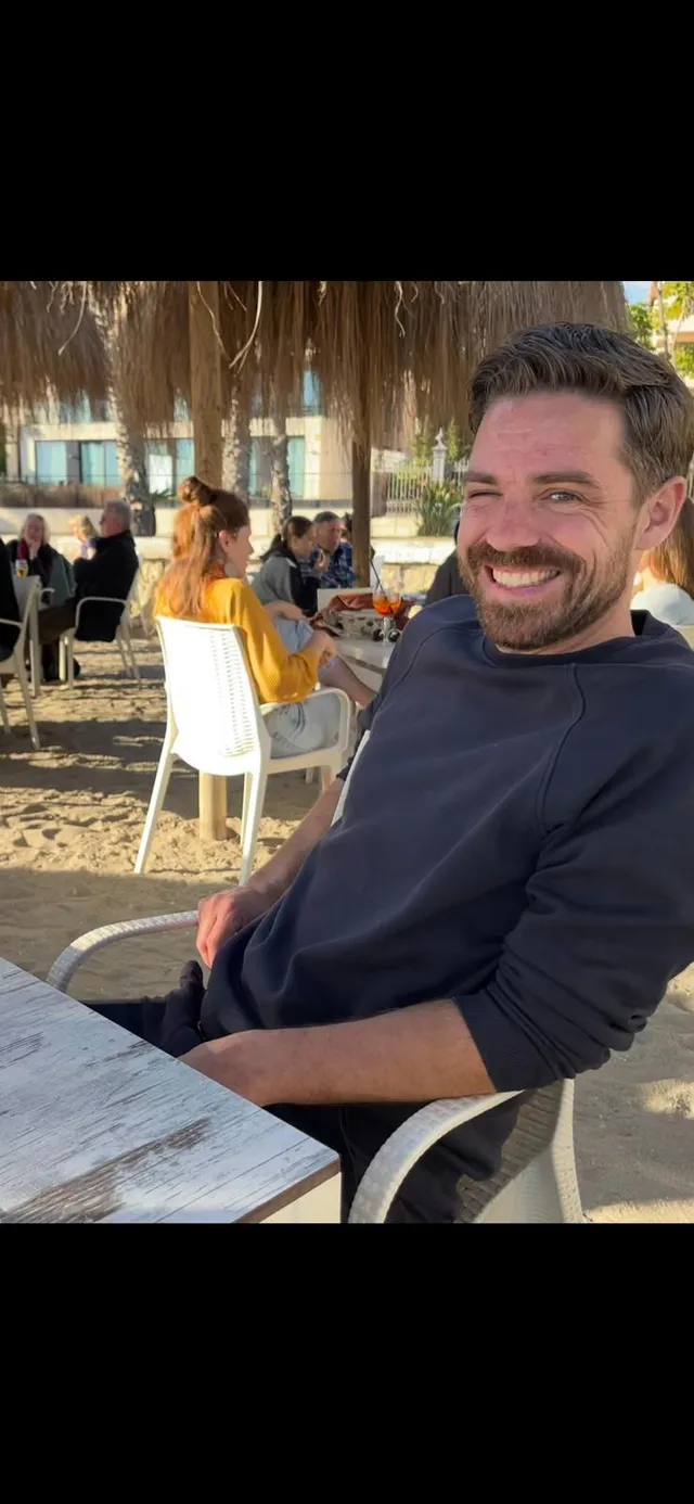 Jesse, founder of Olivings, on a beach