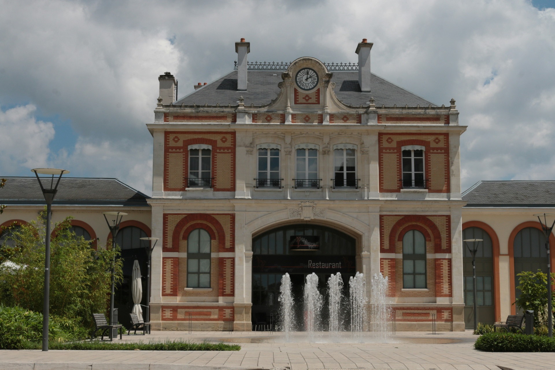 Stone municipal building facade with shuttered windows in a Southern European town